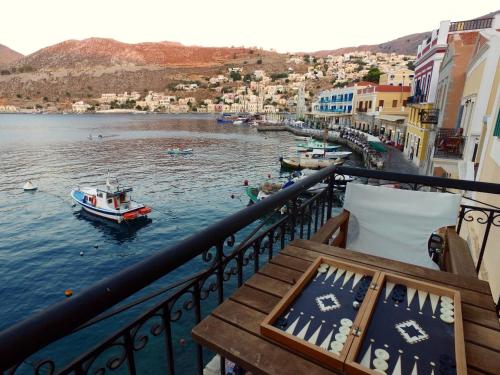 a balcony with a view of a body of water with boats at SeaMe Houses in Symi