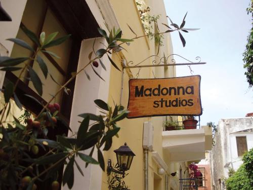 a sign for a madonna studios on the side of a building at Madonna Studios in Chania