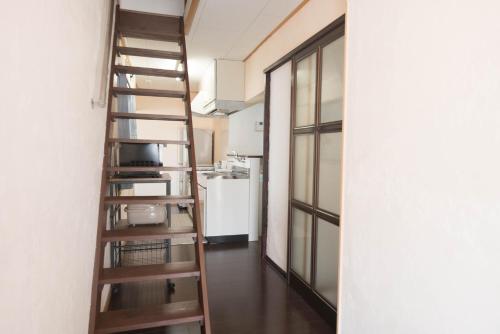 a spiral staircase in a room with a kitchen at グローバルリゾート宮島 天神ハウス in Miyajima