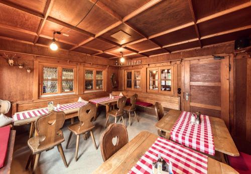 a dining room with wooden tables and chairs at Wannenkopfhütte in Obermaiselstein