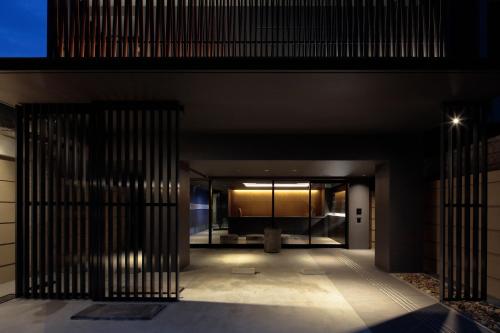 an entrance to a building at night with bars at Hotel Ninja Black in Kyoto