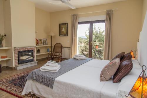 a bedroom with a large bed and a fireplace at La Casona del Torcon in Navahermosa