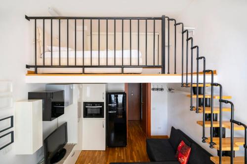 a loft bed in a living room with a couch at PrimoPiano - Inama in Milan