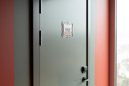 a door with a sign on it next to a window at Best Western Plus Åby Hotel in Mölndal