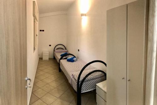 a small room with two beds in a room at Villetta Natalia 2 in Torre Colimena