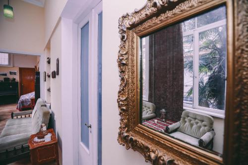 an ornate mirror hanging on a wall next to a room at At Funicular Hostel in Tbilisi City