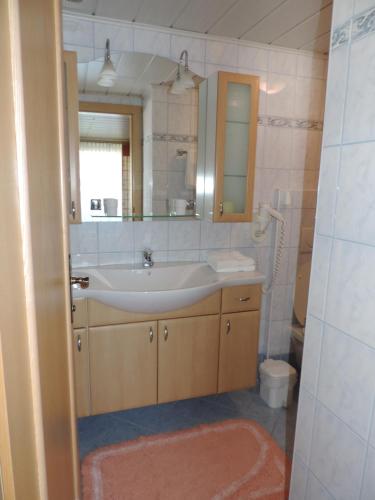 a bathroom with a sink and a mirror at Haus Regina in Strobl