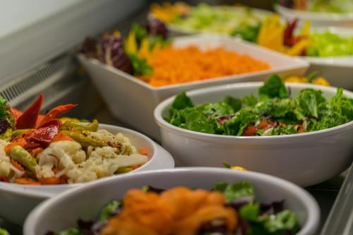 a bunch of bowls of different types of food at Akti Imperial Deluxe Resort & Spa Dolce by Wyndham in Ixia