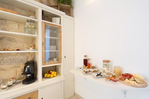 a kitchen with a counter with food on it at Evoca in Ragusa