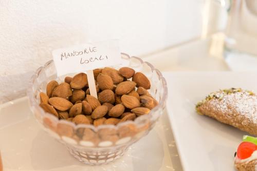 a bowl of nuts and peanuts on a table at Evoca in Ragusa