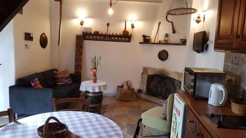 a living room with a couch and a fireplace at Michalis Anoyia Traditional Stonehouse in Kathikas