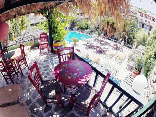 a patio with a table and chairs next to a pool at Villa Rena in Batsi