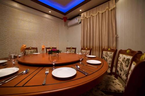 a wooden table with plates and silverware on it at Riverside Hotel in Portsmouth