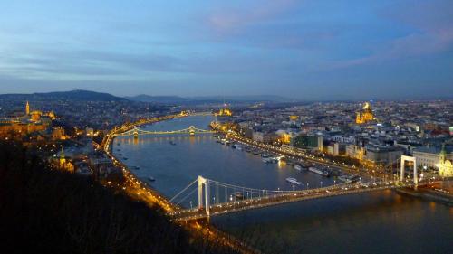 a view of a bridge over a river at night at T62 Hotel in Budapest