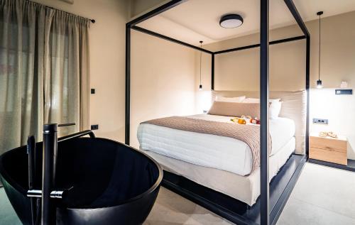 a bedroom with a bed and a black tub at San Giorgio in Fira