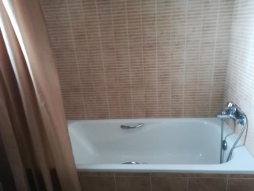 a bath tub in a bathroom with a shower at Casa Rufas in Altea