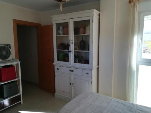 a white cabinet in a room with a bed at Casa Rufas in Altea