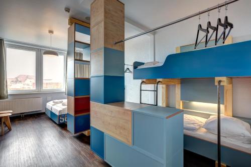 a bedroom with two bunk beds with blue walls at MEININGER Hotel Hamburg City Center in Hamburg