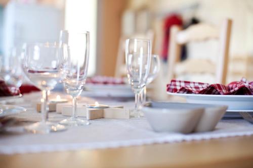 a table with wine glasses and a plate on it at Gîtes Estives d'Arrens in Arrens-Marsous