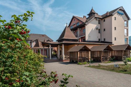 a group of houses with a building at Срібний Водограй in Polyana