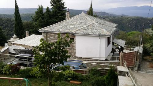 a house with a white door on the side of it at Pacithea Villas in Miléai