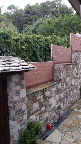 a brick wall with a bench on top of it at Pacithea Villas in Miléai