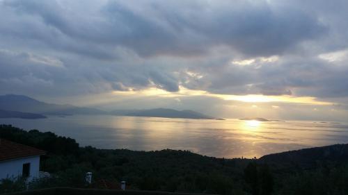 a view of the sun setting over a lake at Pacithea Villas in Miléai
