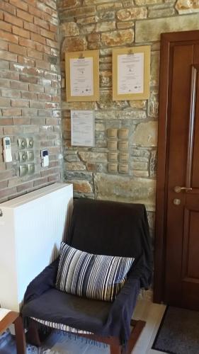 a couch sitting in front of a brick wall at Pacithea Villas in Miléai