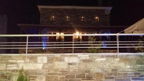 a building at night with lights in the background at Pacithea Villas in Miléai