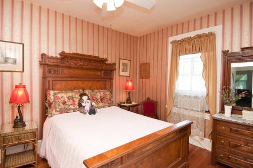 um quarto com uma cama com um cão sentado nela em Thomas Webster House em Cape May