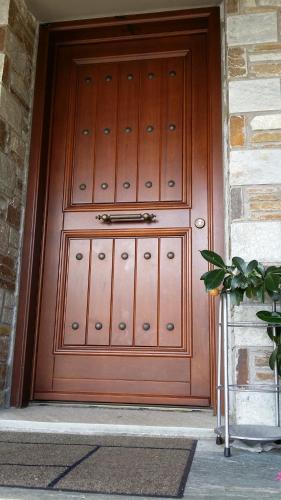 a large wooden door in a building at Pacithea Villas in Miléai