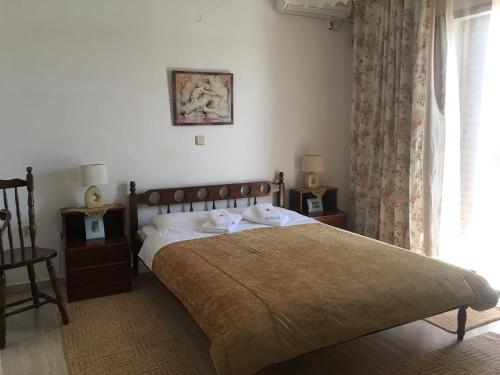a bedroom with a bed and a window at Chris Studios & Apartments in Lechaio