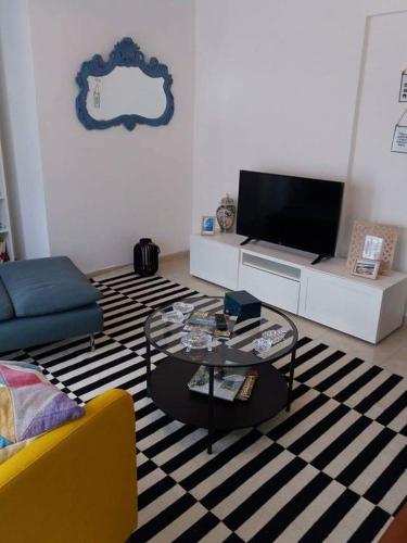 a living room with a couch and a coffee table at A Minha Casa in Sesimbra