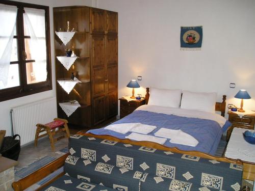 a bedroom with a bed in a room with a window at Studio next to the main Square in Zagora