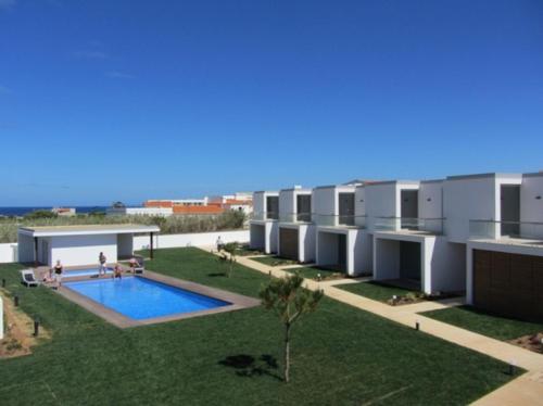 a building with a swimming pool in a yard at Sea Sagres in Sagres