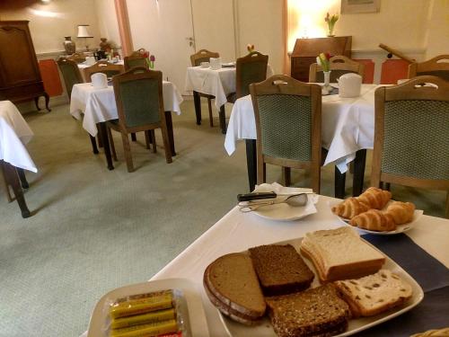 a table with a plate of bread and pastries on it at Schloss Hotel in Düsseldorf