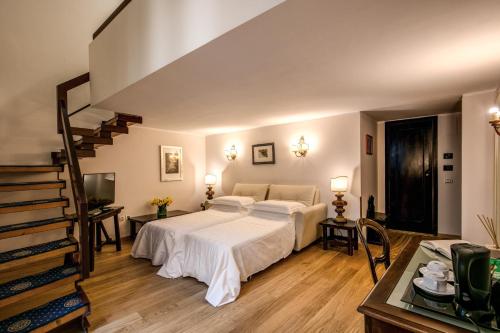 a bedroom with a large bed and a staircase at Hotel Croce Di Malta in Florence