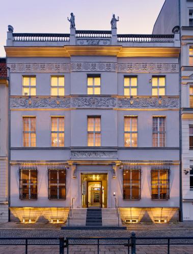 a large white building with stairs in front of it at art'otel berlin mitte, Powered by Radisson Hotels in Berlin