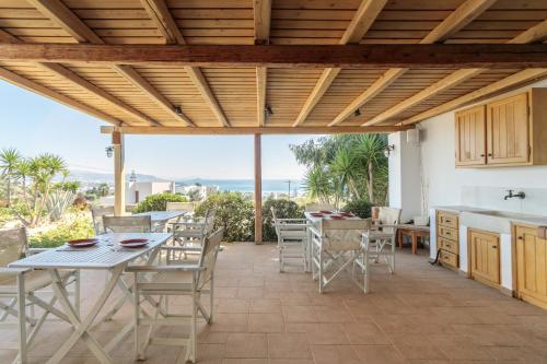 a kitchen and dining room with a table and chairs at Sunrise Studios in Stelida