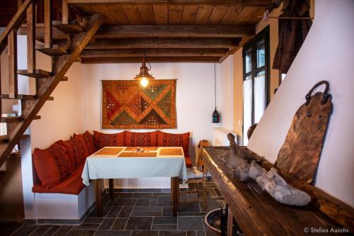 a living room with a table and a couch at Aegean Panorama Apartments in Akhladherí