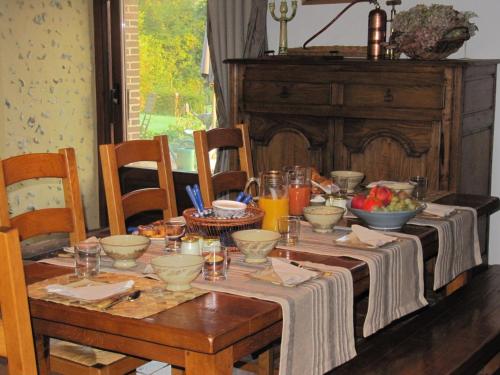 a wooden table with food and drinks on it at RAND'HÔTES in Les Genettes