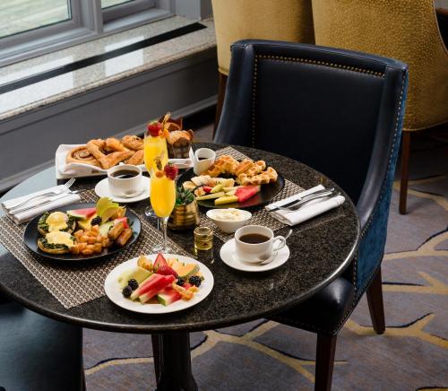 a table with a tray of breakfast food on it at Fairmont Le Chateau Frontenac in Quebec City