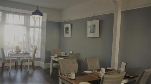 a dining room with a table and chairs and a table and chairsktop at The Lyncroft in Newquay
