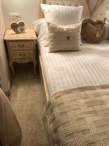 a bedroom with a bed with a nightstand and a bed sidx sidx at Couvent des Carmes in Narbonne