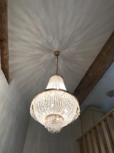 a large white chandelier hanging from a ceiling at Couvent des Carmes in Narbonne