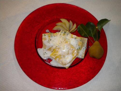 a red plate with a piece of food on it at Albergo Sella - Monte Amiata in Abbadia San Salvatore
