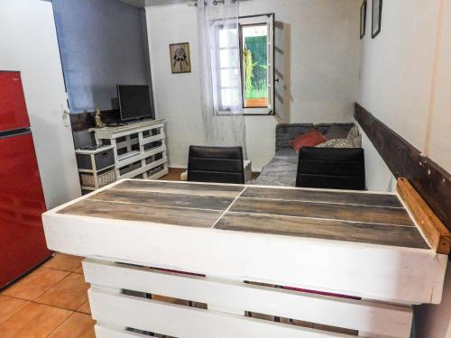 a view of a living room with a bed at Sur la route du Voile in Salazie