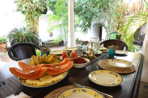 a table with plates of food on top of it at Orchard House Galle in Galle