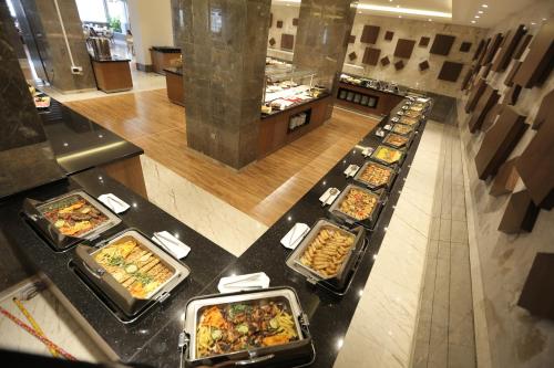 a buffet line with many different types of food at Qasr AlDur Hotel in An Najaf