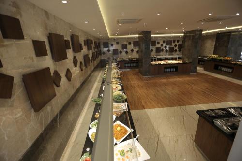 a buffet line of food in a restaurant at Qasr AlDur Hotel in An Najaf